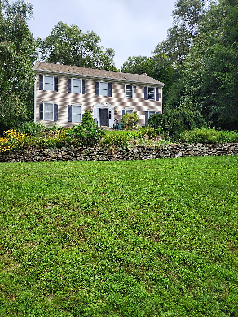 Colonial home with landscaping before solar install