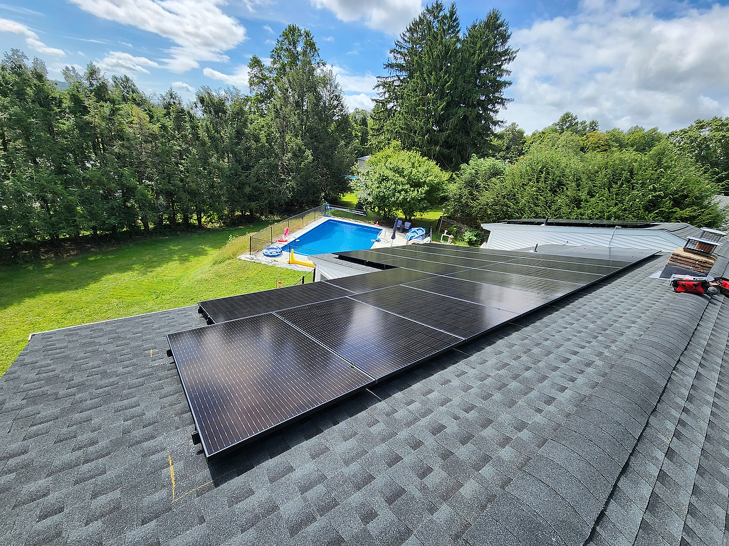 Rooftop solar panels overlooking backyard pool