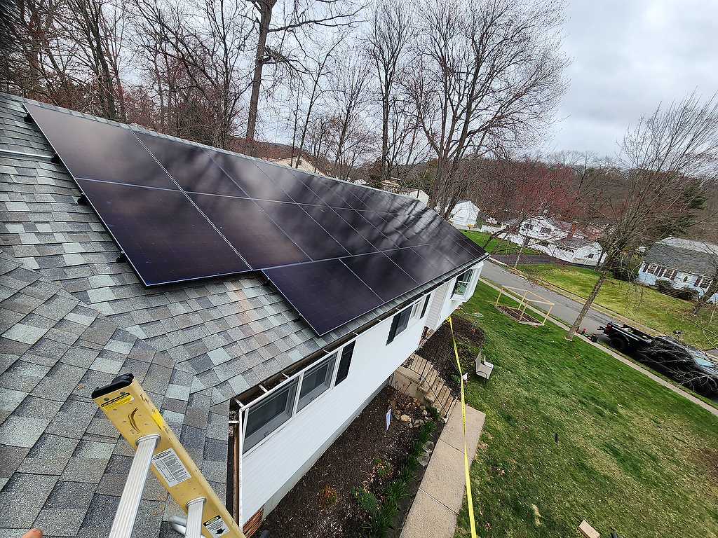 Rooftop solar panel array close-up from ladder
